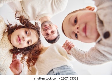 View From Below. Happy Family Looking Down And Having Fun.