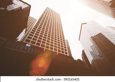 View From Below Of A High-rise Buildings With Contemporary Architecture In Business Center In Day. Tall Modern Skyscrapers Against Grey Sky In Big City