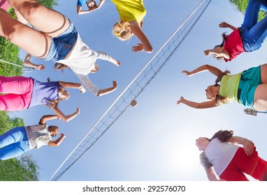 View from below of kids playing volleyball