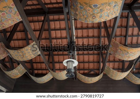 View from below of a unique ornate ceiling structure with Malaysian tile roof upside down traditional architecture decorative ceiling unique design roof tiles wooden beams geometric pattern