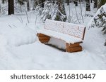 View of bench at Sorsakorpi recreational area in cloudy winter weather, Kerava, Finland.