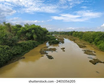 View of the Bengawan Solo river whose water is brown,during sunny day.
					Bengawan Solo is the longest river on the island of Java,Indonesia.