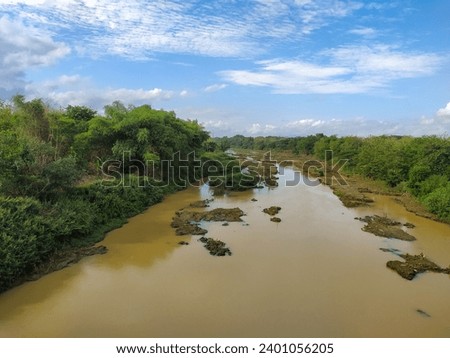View of the Bengawan Solo river whose water is brown,during sunny day.
Bengawan Solo is the longest river on the island of Java,Indonesia.