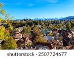 View of Bern city and the Bern History Museum at autumn with the Swiss Alps in the background