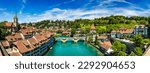 View of the Bern old city center and Nydeggbrucke bridge over river Aare, Bern, Switzerland. Bern old town with the Aare river flowing around the town on a sunny day, Bern, Switzerland.