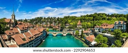 View of the Bern old city center and Nydeggbrucke bridge over river Aare, Bern, Switzerland. Bern old town with the Aare river flowing around the town on a sunny day, Bern, Switzerland.