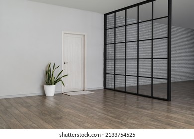 View Of Big Empty Room With Door, Houseplant And Folding Screen