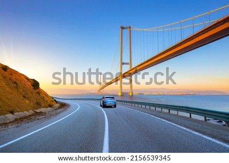 View of big highway bridge in sunny day. highway landscape in summer. Road view with big bridge in the sea. car on the road. asphalt road theme. road landscape in daylight.