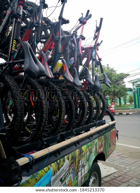 The view of the bikes above\
the pickup car parked across the street. east java Indonesia 2020s\
