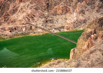 View Of The Black Bridge Over The Bright Green Colorado River in the Grand Canyon
