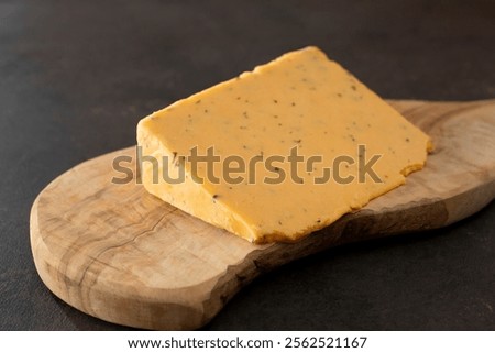 A view of a block of double gloucester cheese.