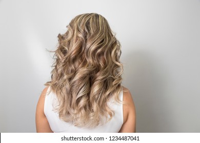 View Of Blonde Curly Hair With Highlights. Selective Focus