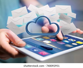 View of a Blue cloud surrounded by realistic envelope email displayed on a futuristic interface - 3d rendering