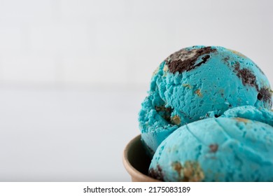 A view of a blue cookie ice cream scoop cup, on the right side of the frame. - Shutterstock ID 2175083189
