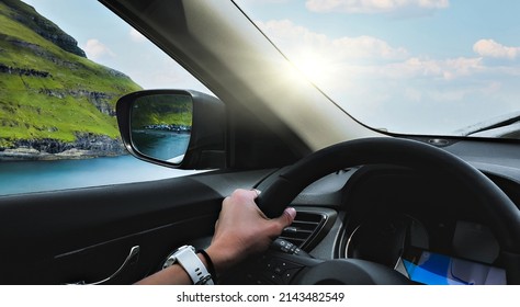 View of blue sea and mountains near calm sea through windscreen of modern car during trip on Faroe Islands a a nice sunny day - Shutterstock ID 2143482549