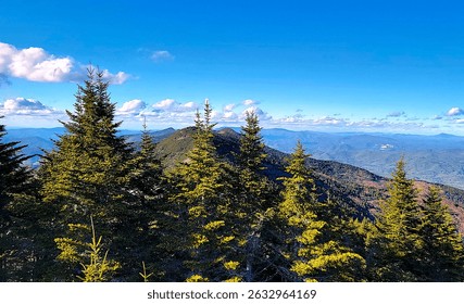 view of blue sky, clouds and high mountains as seen from the summit of Mount Mitchell, NC