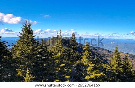view of blue sky, clouds and high mountains as seen from the summit of Mount Mitchell, NC