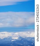 View of blue sky with clouds over mountains