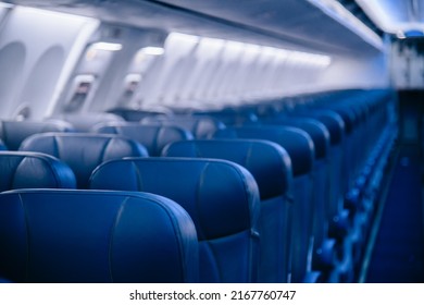 View Of Blurred Empty Passenger Airplane Seats In The Cabin In Blue Colored, Blurred Of Empty Seat In The Aircraft