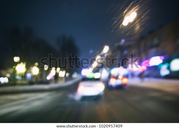 View of blurred road with lots of cars and light\
from the driver\'s eyes