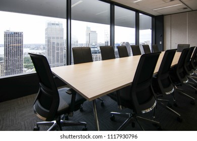 View of a board room within a larger office with a view of the cityscape from the near by window with plenty of natural light  modern office fitout