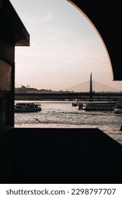 a view of a body of water with a bridge in the background, a picture by Radi Nedelchev, trending on unsplash, constructivism, shallow depth of field, photo taken with ektachrome, depth of field
				