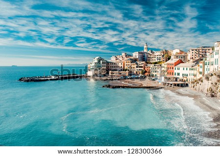 View of Bogliasco. Bogliasco is a ancient fishing village in Italy, Genoa, Liguria. Mediterranean Sea, sandy beach and architecture of Bogliasco town. Cloudy blue sky sunny day idyllic scenery, winter