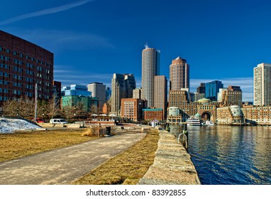 view of boston harbor and rowes wharf and skyscraper buildings in south boston massachusetts in winter.