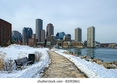 view of boston harbor and rowes wharf and skyscraper buildings in south boston massachusetts in winter.