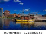 View of Boston Tea Party Ship & Museum over Fort Point Channel under blue sky in downtown Boston, USA