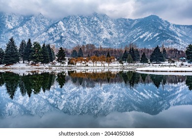 A view of botanical garden with lake in winter season, and the beautiful mountain range in the background in the city of Srinagar, Kashmir, India