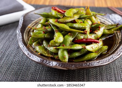 A View Of A Bowl Of Spicy Edamame Bean Pods.