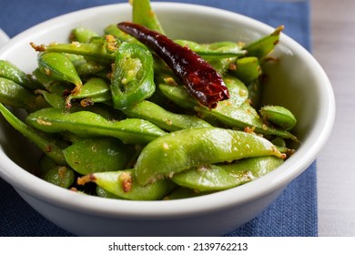 A View Of A Bowl Of Spicy Edamame Bean Pods.