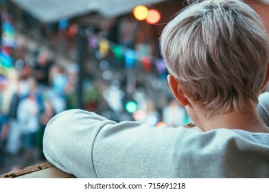 View Of Boy From Behind Looking At Crowd From Above, Looking At Crowd