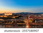 View of Bratislava castle, old town and the Danube river from observation deck the bridge in Bratislava, Slovakia at night