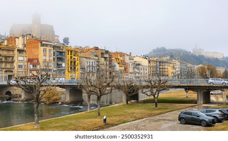 View of bridge over Segre River in Catalonia - town of Balaguer. Foggy morning in ancient European city - Powered by Shutterstock