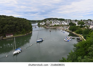 View of the brittany village of Le Bono dominating the Auray River where boats are parked, seen from a bridge