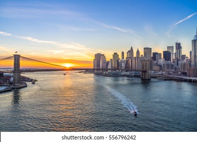 view of Brooklyn Bridge and Manhattan skyline at sunset
