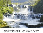 View of the Štrbački buk waterfall, located in the Una National Park on the border of Croatia and Bosnia and Herzegovina. Landscape with a large waterfall cascading down.