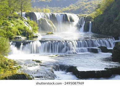 View of the Štrbački buk waterfall, located in the Una National Park on the border of Croatia and Bosnia and Herzegovina. Landscape with a large waterfall cascading down. - Powered by Shutterstock