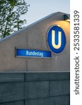 A view of the Bundestag U-Bahn station entrance in Berlin, Germany, with clear signage and modern architecture.