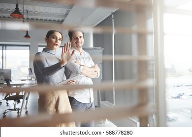 View Of Business Couple Working In Office 