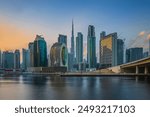 View of the business and financial center of Dubai in the United Arab Emirates. Skyscrapers in the evening at sunset. Sunlight reflection on the glass surfaces of the skyscrapers with some clouds