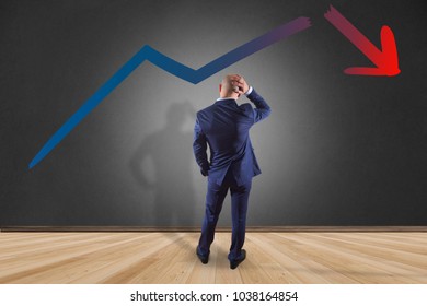 View Of A Businessman In Front Of A Wall Thinking About Problem Facing A Business Arrow Breaking Down - Business Concept