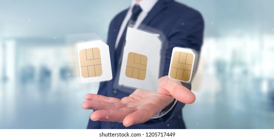 View Of A Businessman Holding Different Size Of A Smartphone Sim Card 