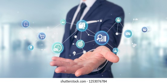 View of a Businessman holding a Logistic organisation with icon and connection 3d rendering - Shutterstock ID 1253076784