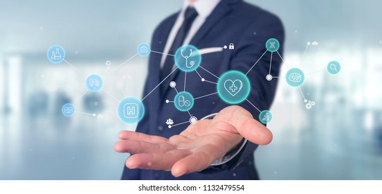 View of a Businessman holding Medical icon and connection 3d rendering - Shutterstock ID 1132479554