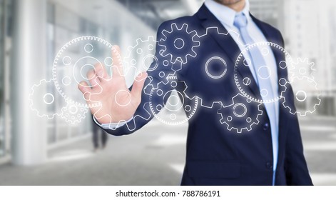 View of a Businessman touching technology interface with gear wheel setting