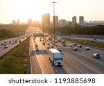 View of busy Highway 401 in Toronto Canada with reflection and high rise buildings during rush hours at the sunset