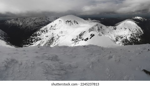 View from Bystra in winter aura. Winter holidays in the Polish mountains. Tatra Mountains. Mountain hiking in crampons and with an ice-check. View on Starorobocianski Wierch.